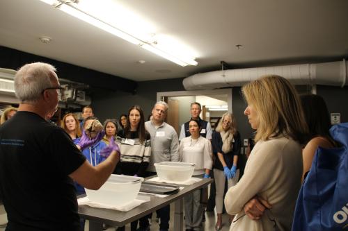 Parent Day 2023 - parents and their kids look at Len White holding a human brain