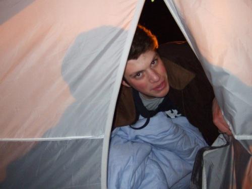 Matthew Slayton laying in tent at Duke's K-Ville.