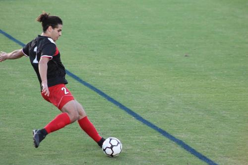 K. Abdelaal kicking a soccer ball on a field.